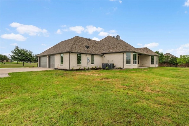 10817 Ridge Country Rd, Haslet, TX 76052 - back of property with central AC, concrete driveway, a lawn, a garage, and a chimney