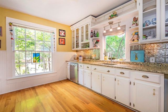 1909 Alston Ave, Fort Worth, TX 76110 - kitchen featuring stainless steel dishwasher, open shelves, a sink, a wainscoted wall, and white cabinetry