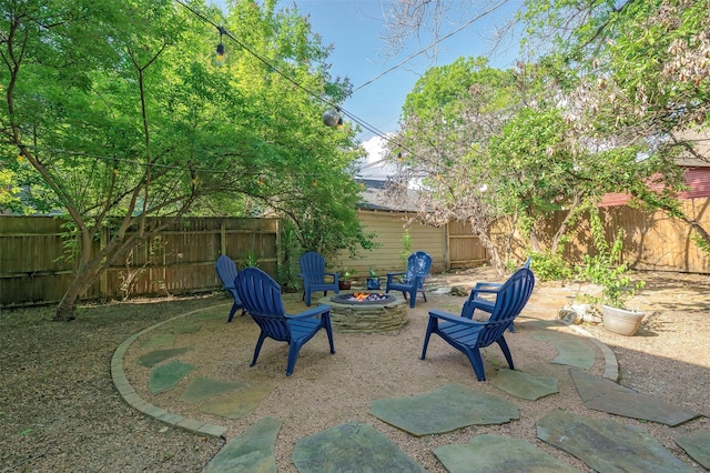 1909 Alston Ave, Fort Worth, TX 76110 - fenced backyard with a fire pit and a patio area