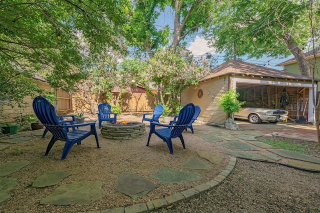 1909 Alston Ave, Fort Worth, TX 76110 - view of yard featuring a fire pit, a patio, and a garage