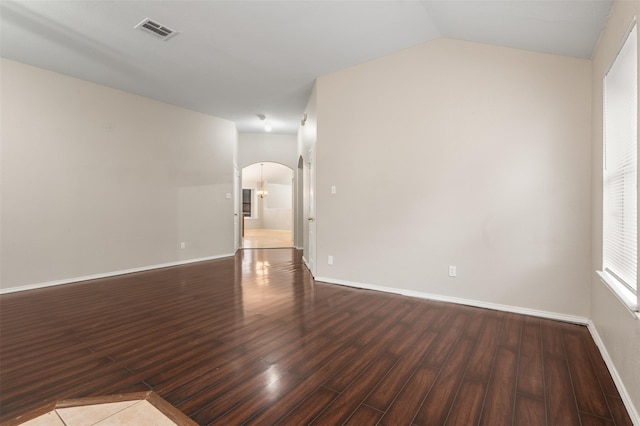 648 Tabasco Trl, Arlington, TX 76002 - empty room with arched walkways, dark wood-style floors, baseboards, and lofted ceiling