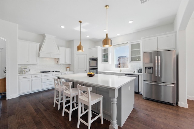 506 Prairie Run, Aledo, TX 76008 - kitchen with appliances with stainless steel finishes, premium range hood, a center island, decorative backsplash, and white cabinetry