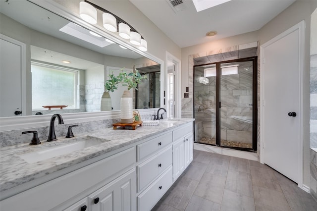 4704 N Meadow Ridge Cir, Mckinney, TX 75072 - full bath featuring a stall shower, double vanity, and a skylight