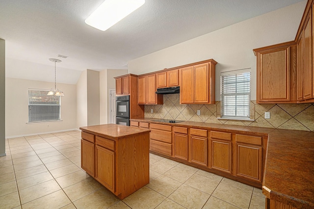 5516 La Bandera Trl, Benbrook, TX 76126 - kitchen featuring under cabinet range hood, black appliances, backsplash, brown cabinets, and a center island