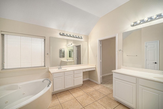5516 La Bandera Trl, Benbrook, TX 76126 - bathroom featuring vaulted ceiling, a whirlpool tub, two vanities, and tile patterned floors