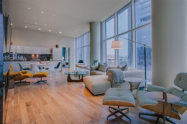 1918 N Olive St Unit 302, Dallas, TX 75201 - living area featuring a high ceiling, expansive windows, light wood-type flooring, and recessed lighting