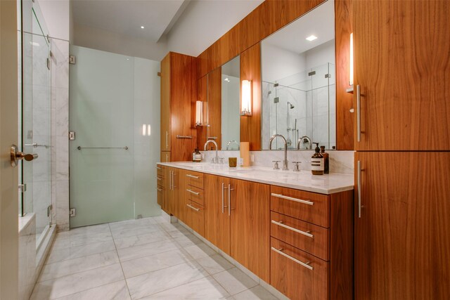 1918 N Olive St Unit 302, Dallas, TX 75201 - bathroom with double vanity, a shower stall, and marble finish flooring