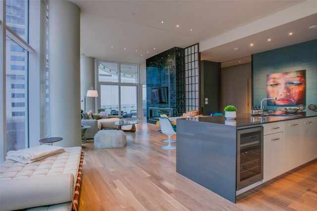 1918 N Olive St Unit 302, Dallas, TX 75201 - indoor wet bar featuring wine cooler, a wall of windows, light wood-style floors, and recessed lighting