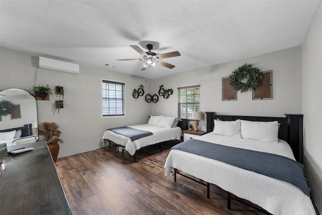 102 Creek Dr, Whitney, TX 76692 - bedroom featuring an AC wall unit, wood finished floors, ceiling fan, and a textured ceiling
