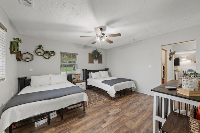 102 Creek Dr, Whitney, TX 76692 - bedroom featuring wood finished floors, a textured ceiling, and ceiling fan