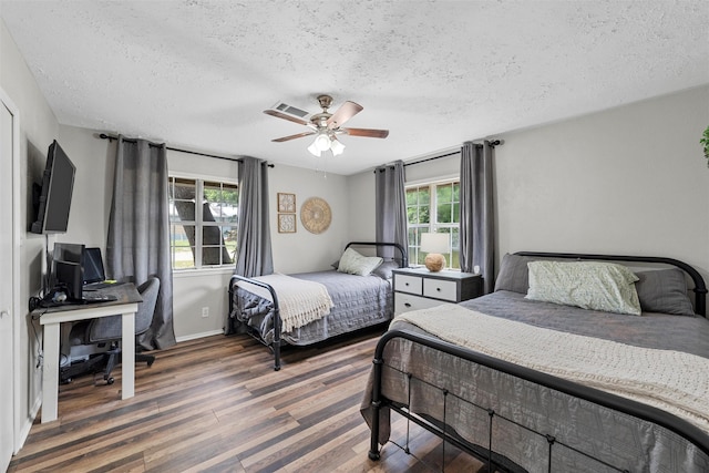 102 Creek Dr, Whitney, TX 76692 - bedroom featuring a textured ceiling, wood finished floors, an office area, a ceiling fan, and baseboards