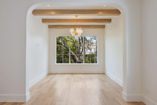 1801 Loving Ave, Dallas, TX 75214 - unfurnished dining area with arched walkways, a chandelier, beamed ceiling, light wood-style floors, and baseboards