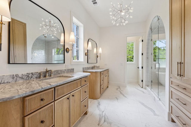 1801 Loving Ave, Dallas, TX 75214 - bathroom featuring a chandelier, two vanities, a stall shower, and marble tiled floors