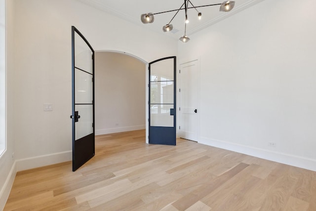 1801 Loving Ave, Dallas, TX 75214 - empty room with wood finished floors, a chandelier, baseboards, and arched walkways