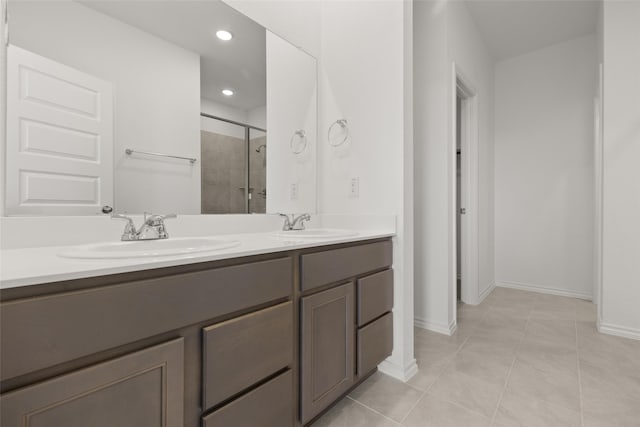 3121 Dixondale Dr, Fort Worth, TX 76108 - bathroom featuring a shower stall, double vanity, baseboards, recessed lighting, and tile patterned flooring
