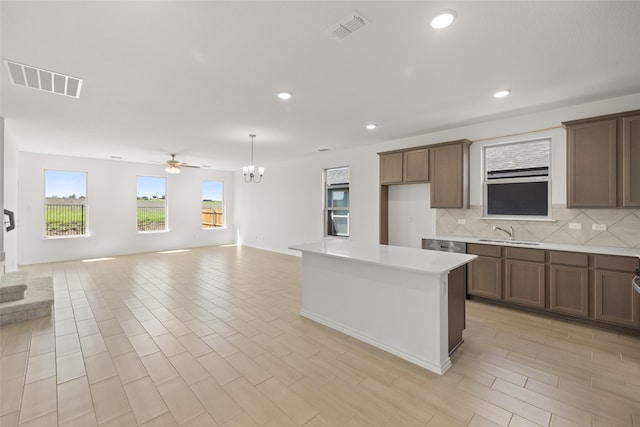 3121 Dixondale Dr, Fort Worth, TX 76108 - kitchen with a sink, open floor plan, decorative backsplash, light countertops, and recessed lighting