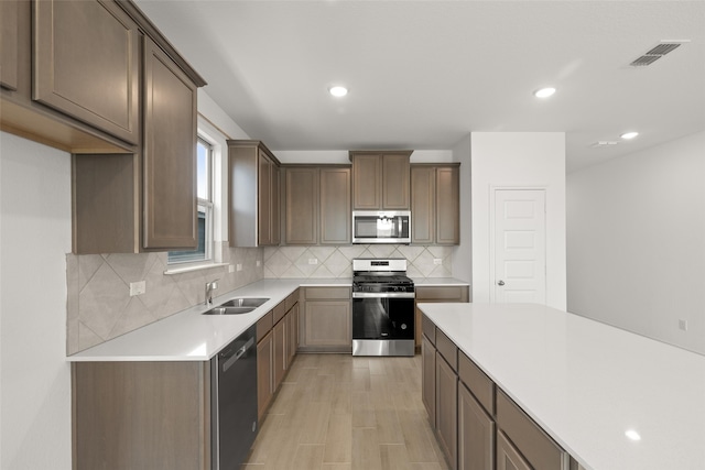 3121 Dixondale Dr, Fort Worth, TX 76108 - kitchen featuring stainless steel appliances, a sink, tasteful backsplash, light countertops, and recessed lighting