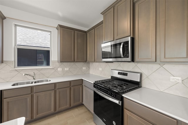 3121 Dixondale Dr, Fort Worth, TX 76108 - kitchen featuring appliances with stainless steel finishes, a sink, backsplash, and light countertops