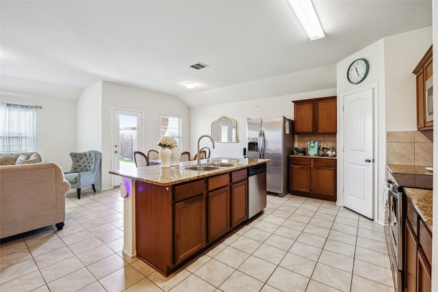 806 Opal Path, Princeton, TX 75407 - kitchen featuring stainless steel appliances, open floor plan, light tile patterned floors, a kitchen island with sink, and a sink