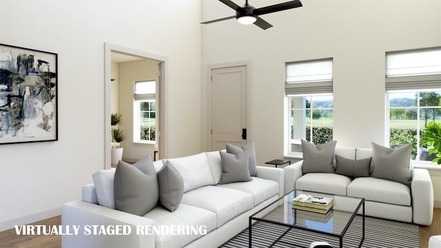 9484 Hedge St, Frisco, TX 75035 - living room featuring wood finished floors, a ceiling fan, baseboards, and a towering ceiling