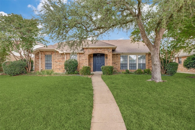 6704 Wesson Dr, Plano, TX 75023 - view of front of house with a front lawn, brick siding, and a shingled roof