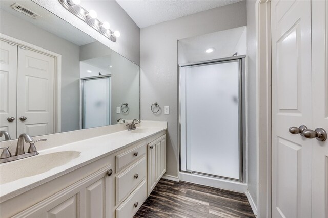 6704 Wesson Dr, Plano, TX 75023 - full bath featuring a shower stall, double vanity, wood finished floors, and baseboards