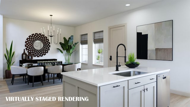 9434 Hedge St, Frisco, TX 75035 - kitchen with stainless steel dishwasher, a sink, light countertops, light wood finished floors, and pendant lighting
