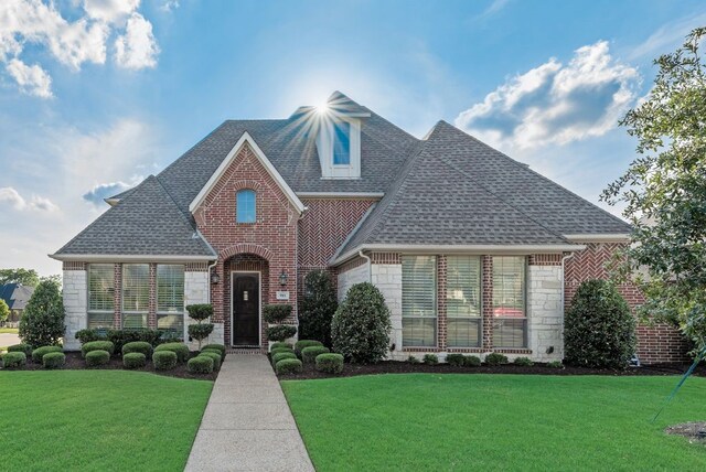 901 Jessica Ln, Prosper, TX 75078 - view of front facade featuring a shingled roof, brick siding, and a front lawn
