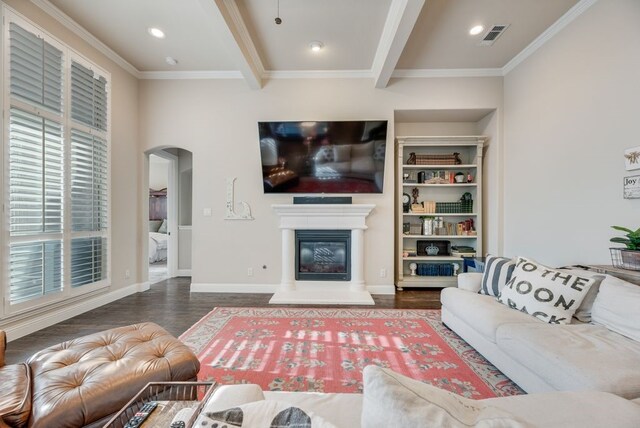 901 Jessica Ln, Prosper, TX 75078 - living room featuring arched walkways, wood finished floors, crown molding, a glass covered fireplace, and baseboards
