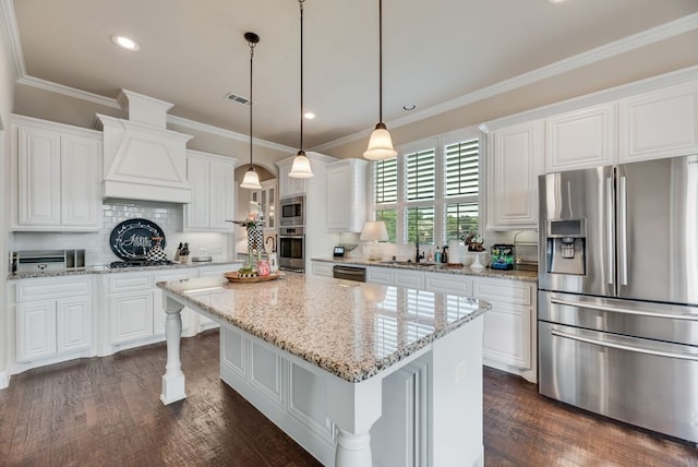 901 Jessica Ln, Prosper, TX 75078 - kitchen with stainless steel appliances, custom range hood, white cabinets, dark wood finished floors, and a sink