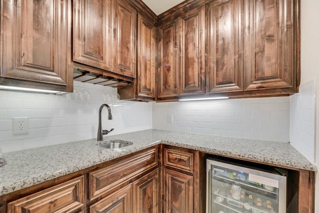 901 Jessica Ln, Prosper, TX 75078 - kitchen featuring wine cooler, a sink, tasteful backsplash, and light stone counters