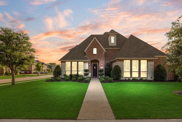 901 Jessica Ln, Prosper, TX 75078 - french country home featuring brick siding, a front lawn, and a shingled roof
