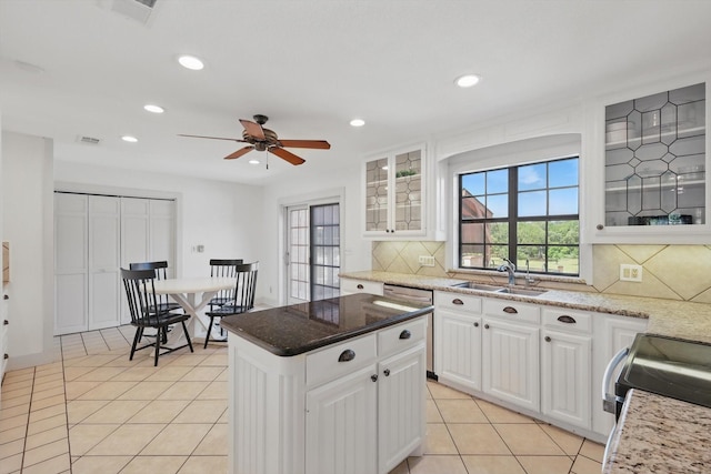 1189 W Jeter Rd, Bartonville, TX 76226 - kitchen with decorative backsplash, light tile patterned flooring, a ceiling fan, glass insert cabinets, and recessed lighting