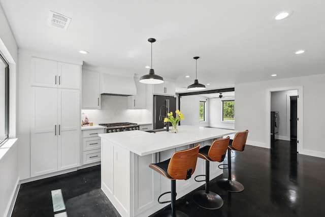 1189 W Jeter Rd, Bartonville, TX 76226 - kitchen with recessed lighting, freestanding refrigerator, premium range hood, a center island with sink, and light countertops