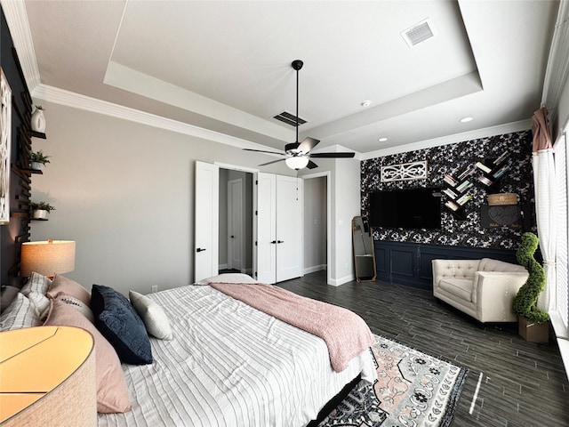 1015 Sable Dr, Rockwall, TX 75087 - bedroom with a raised ceiling, dark wood-style floors, recessed lighting, crown molding, and baseboards