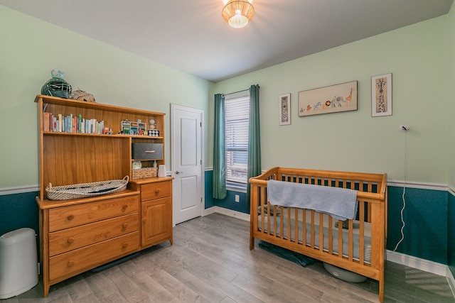 812 Holler Loop, Fort Worth, TX 76247 - bedroom with light wood-style floors, baseboards, and a nursery area