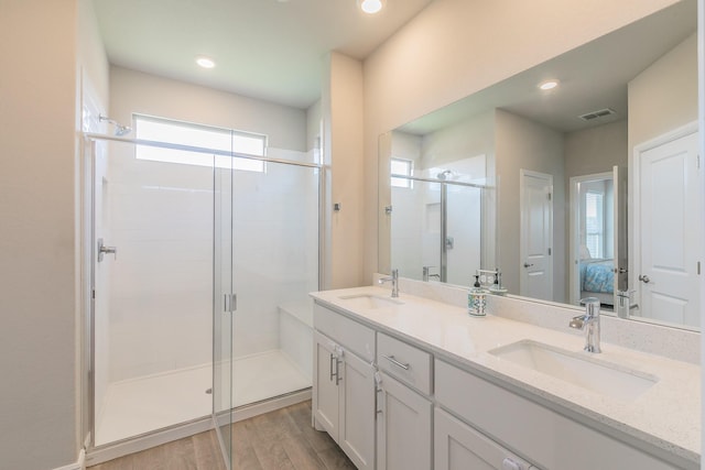 812 Holler Loop, Fort Worth, TX 76247 - full bathroom featuring double vanity, connected bathroom, a stall shower, wood finished floors, and recessed lighting