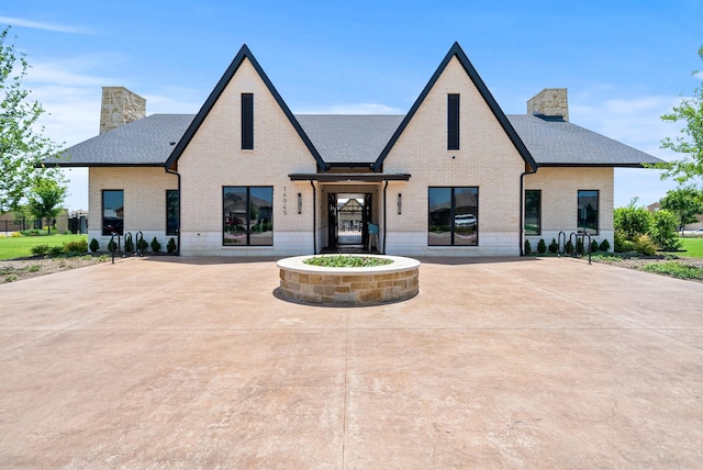 812 Holler Loop, Fort Worth, TX 76247 - view of front of property with a chimney, brick siding, and a shingled roof