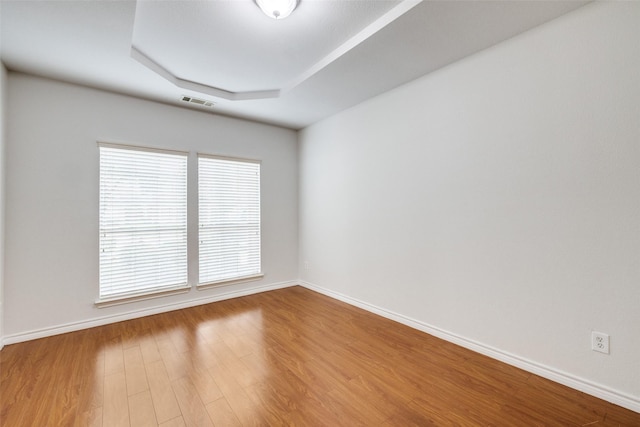 5283 W Cove Way, Grand Prairie, TX 75052 - empty room featuring a raised ceiling, wood finished floors, and baseboards