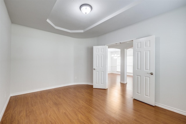 5283 W Cove Way, Grand Prairie, TX 75052 - empty room featuring a chandelier, wood finished floors, baseboards, and a tray ceiling