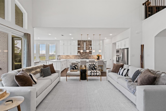 1720 Rolling Heights Ln, Fort Worth, TX 76008 - living room featuring a towering ceiling, arched walkways, light wood-style flooring, and recessed lighting