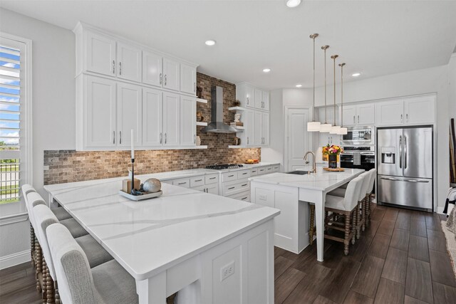 1720 Rolling Heights Ln, Fort Worth, TX 76008 - kitchen with stainless steel appliances, wall chimney exhaust hood, plenty of natural light, a kitchen breakfast bar, and recessed lighting