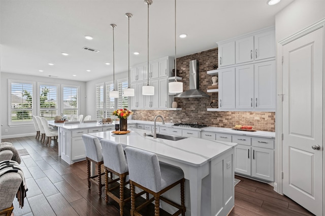 1720 Rolling Heights Ln, Fort Worth, TX 76008 - kitchen with a sink, wall chimney exhaust hood, an island with sink, light countertops, and recessed lighting