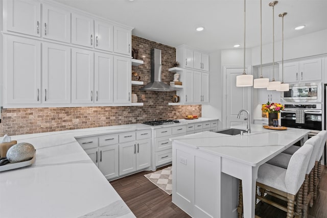 1720 Rolling Heights Ln, Fort Worth, TX 76008 - kitchen featuring stainless steel appliances, a sink, wall chimney range hood, decorative backsplash, and dark wood-style flooring