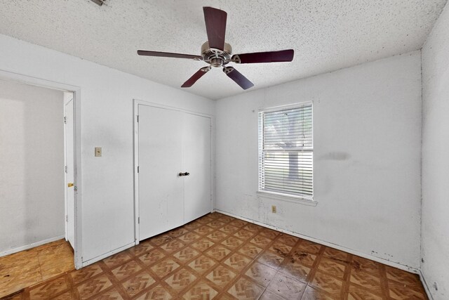 8512 Whitney Dr, White Settlement, TX 76108 - unfurnished bedroom featuring a textured ceiling, a closet, and a ceiling fan