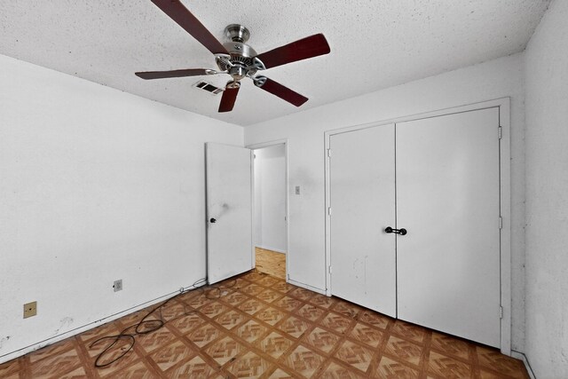 8512 Whitney Dr, White Settlement, TX 76108 - unfurnished bedroom with a closet, a textured ceiling, ceiling fan, and light floors