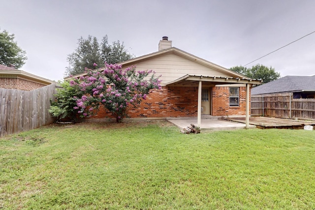 8512 Whitney Dr, White Settlement, TX 76108 - rear view of house featuring a patio, brick siding, and a chimney