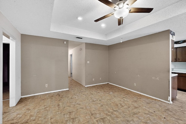 8512 Whitney Dr, White Settlement, TX 76108 - unfurnished bedroom featuring a raised ceiling, baseboards, recessed lighting, a textured ceiling, and a ceiling fan