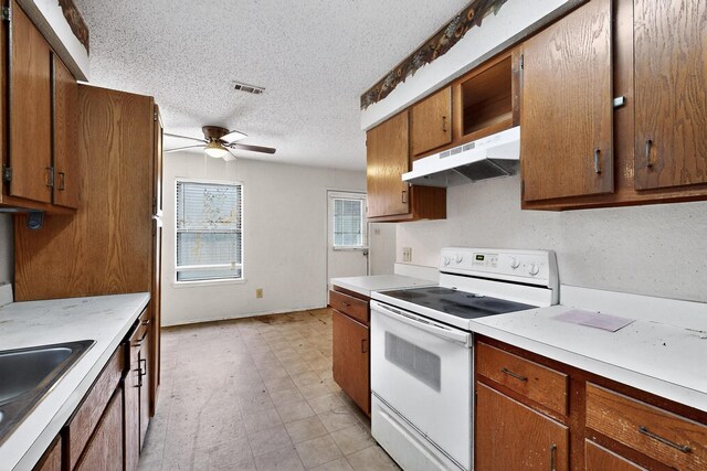 8512 Whitney Dr, White Settlement, TX 76108 - kitchen featuring white range with electric cooktop, under cabinet range hood, a textured ceiling, ceiling fan, and light countertops