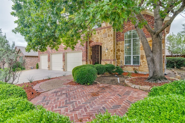 105 Cassandra Dr, Forney, TX 75126 - view of front of house featuring stone siding, driveway, brick siding, and a garage